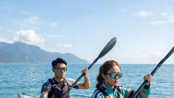 Two kayakers wearing performance sunglasses on bright open seawater