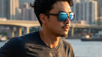 Runner wearing 2nu sunglasses along a Hong Kong waterfront, showing stable fit for humid outdoor runs