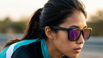 Road cyclist wearing 2nu sunglasses with purple mirrored lenses in warm outdoor light, showing glare and lens tint conditions