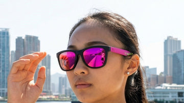 Hong Kong waterfront runner wearing 2nu sunglasses with reflective lenses in bright outdoor light