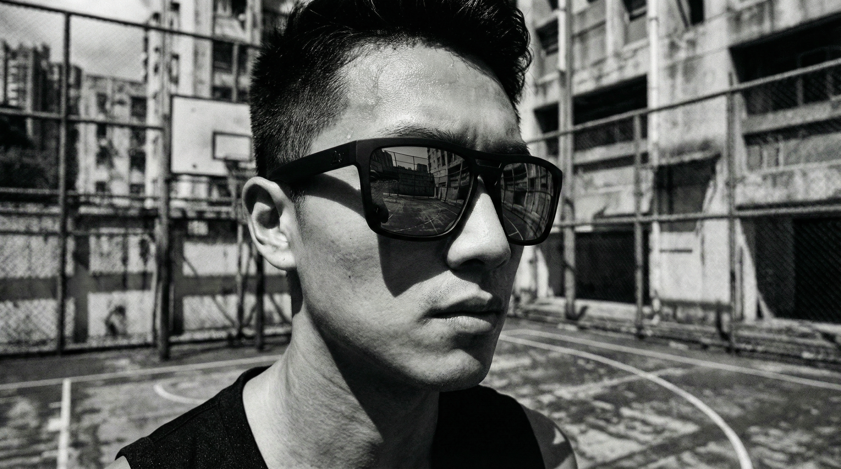 Person adjusting lightweight sunglasses outdoors in humid tropical morning conditions.