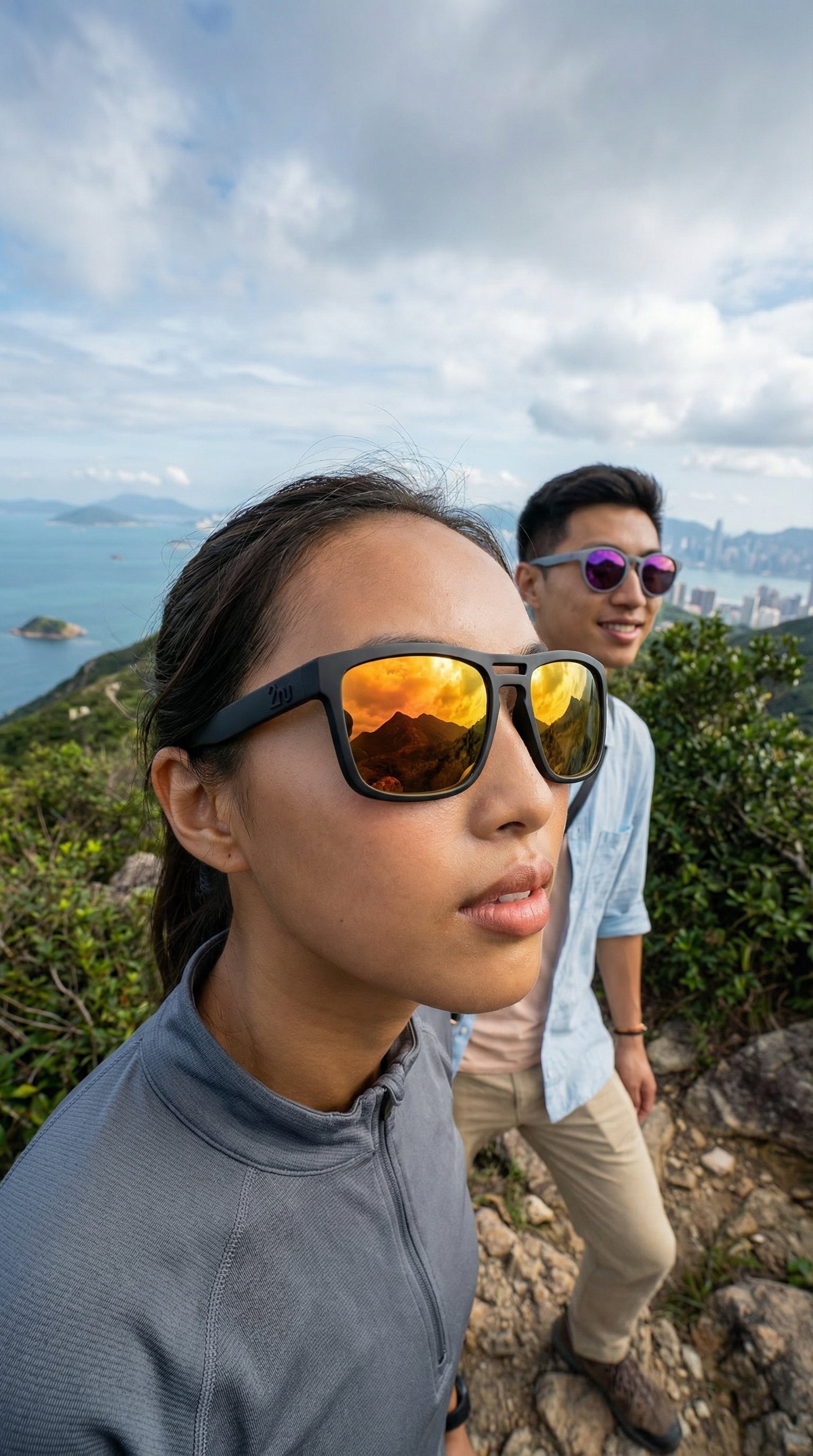 Two hikers wearing performance sunglasses on a scenic trail, representing stable eyewear fit during downhill hiking