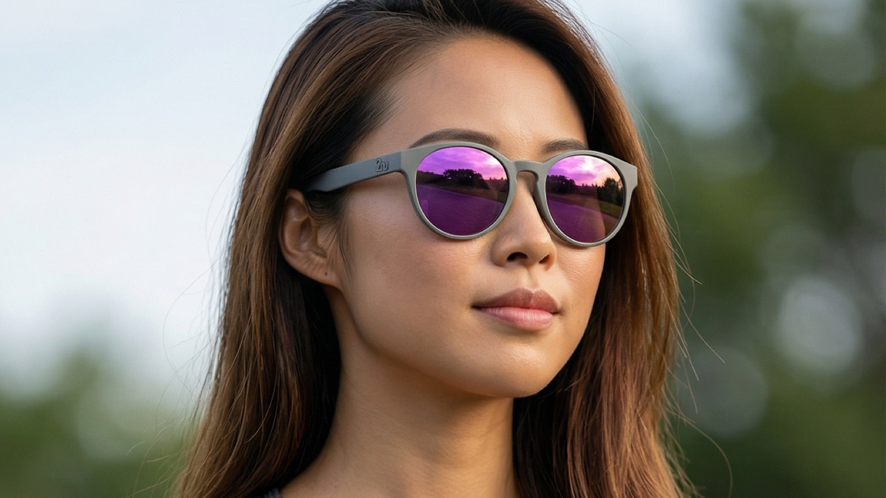 Woman wearing 2nu sunglasses with vibrant reflective lenses outdoors, showing lens colour and screen-readability considerations