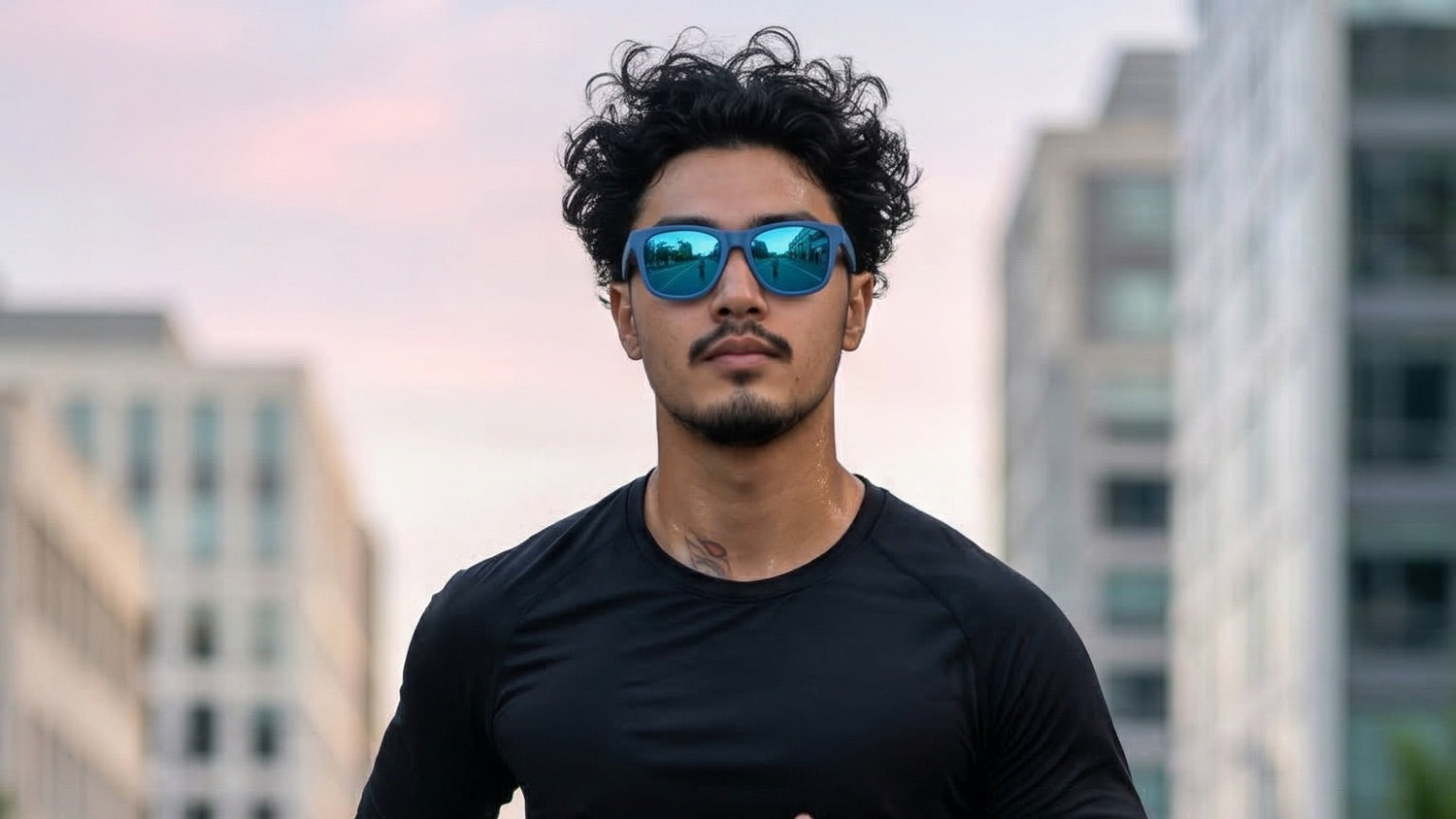 Urban runner wearing performance sunglasses with visible perspiration during a humid outdoor run