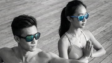Two Asian athletes wearing performance sunglasses during an outdoor training session