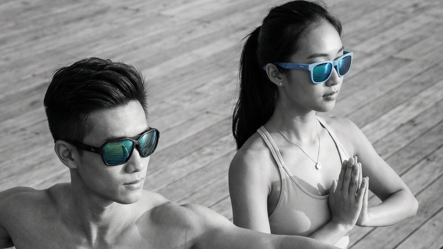 Two Asian athletes wearing performance sunglasses during an outdoor training session