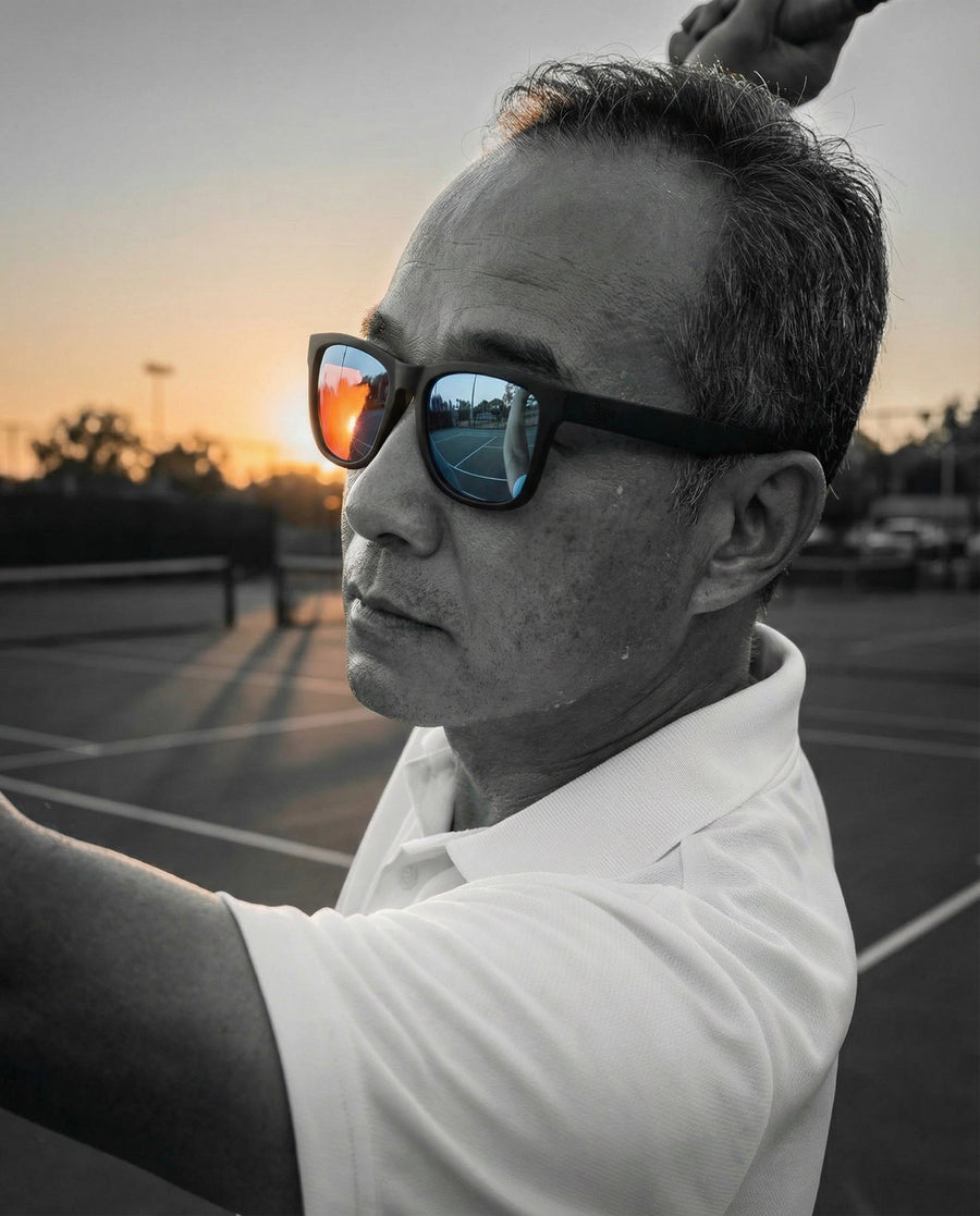 Man wearing Fancy sunglasses outdoors at sunset