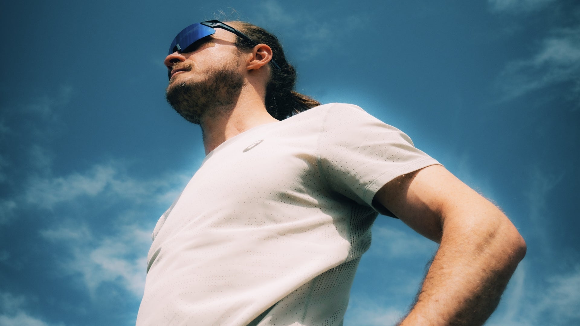 Runner wearing 2nu performance sunglasses on a bright outdoor route for the Running and Driving sunglasses guide.